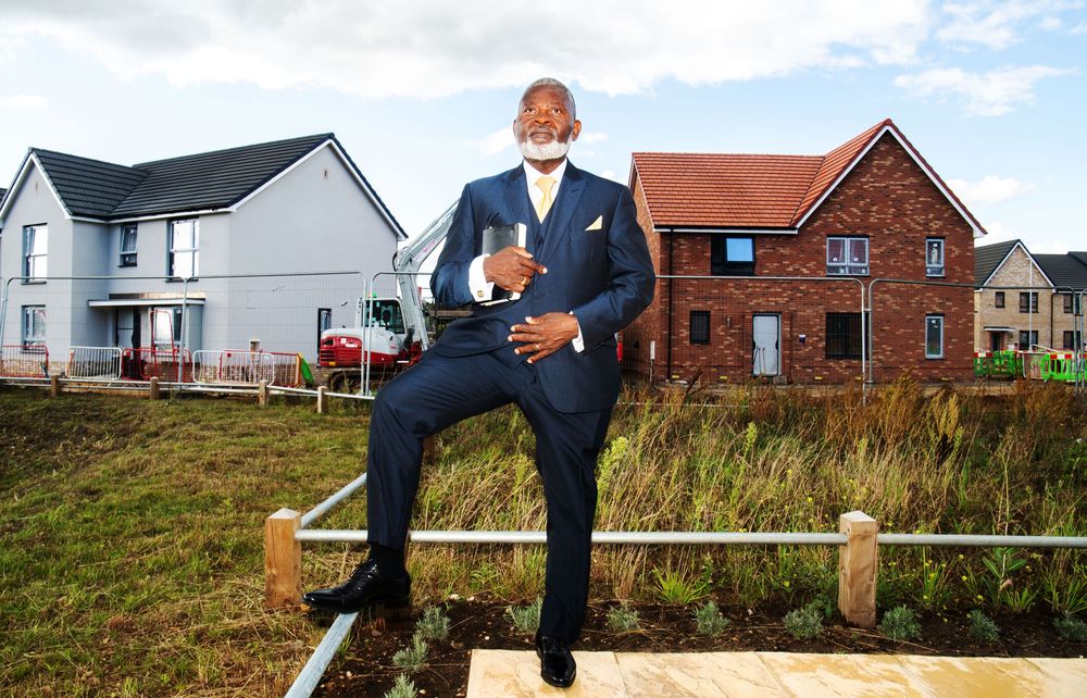 Commercial portrait of property developer Francis Sheuk-Fobbie outside new homes in Ipswich, Suffolk