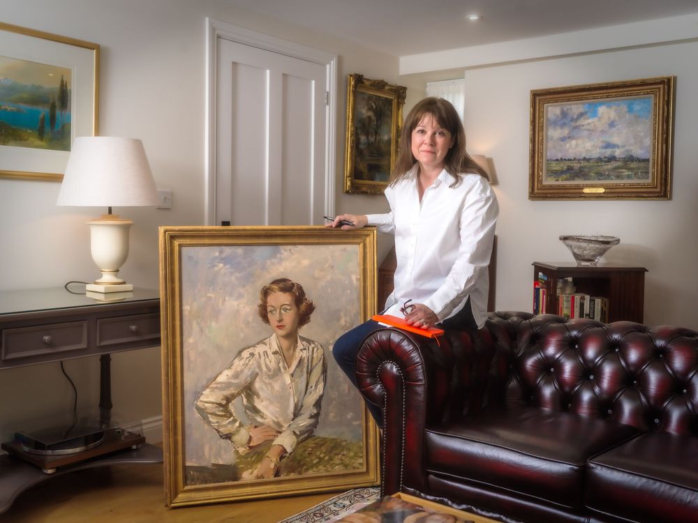 Editorial portrait of Gallerist Lucy Charles with one of her pieces of art, at her offices in Yoxford, Suffolk.