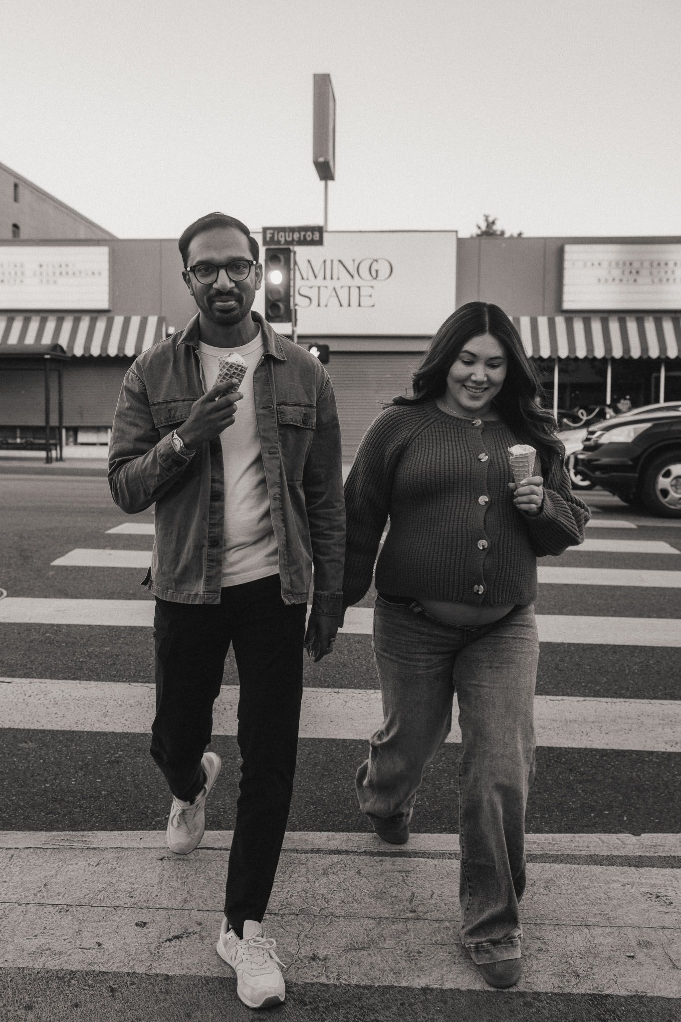 Black and white photo of Amanda and Rohan walking hand in hand during their Pasadena maternity session
