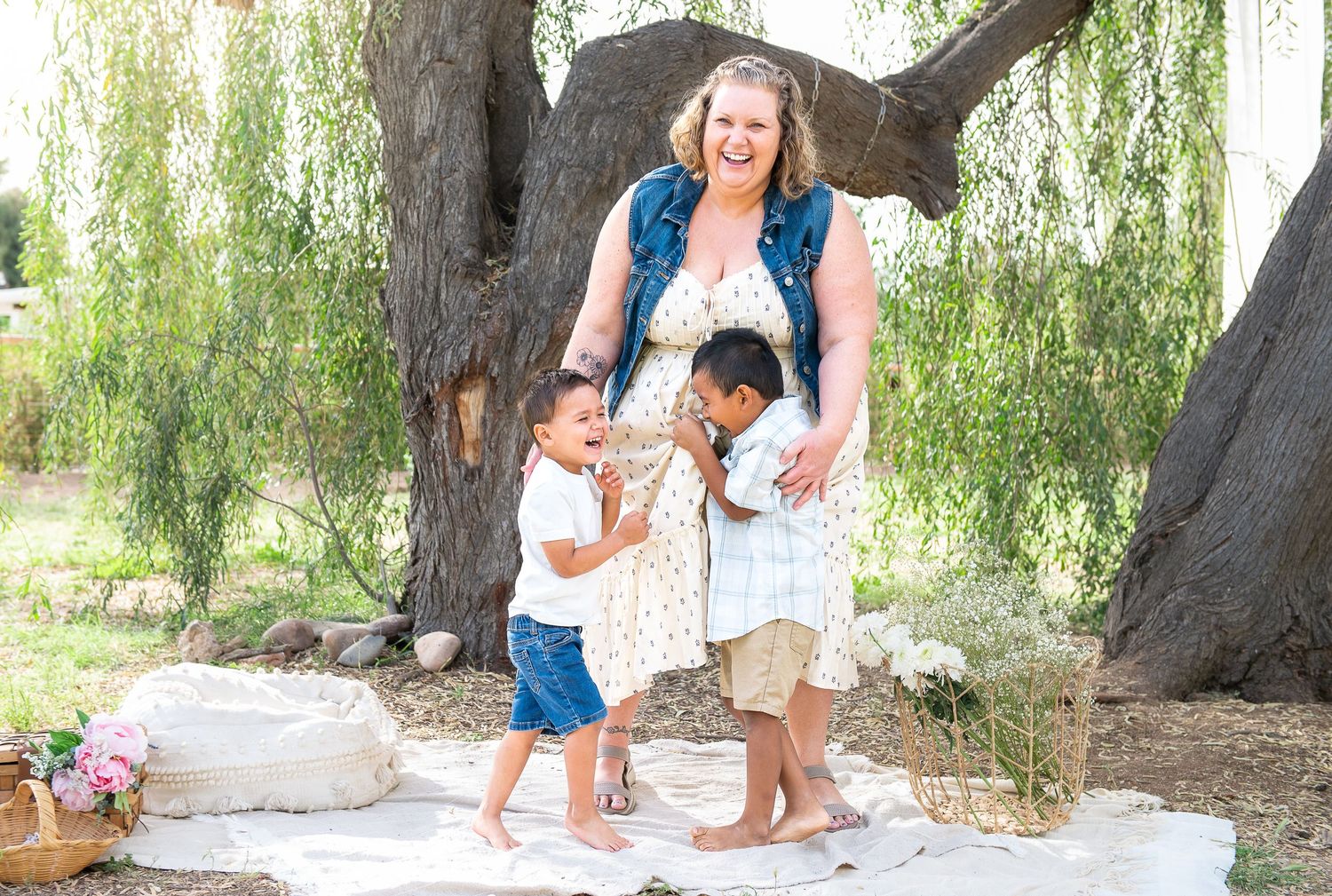 Mom and sons hug and laugh in the shade of a Willow Tree in the East Valley.