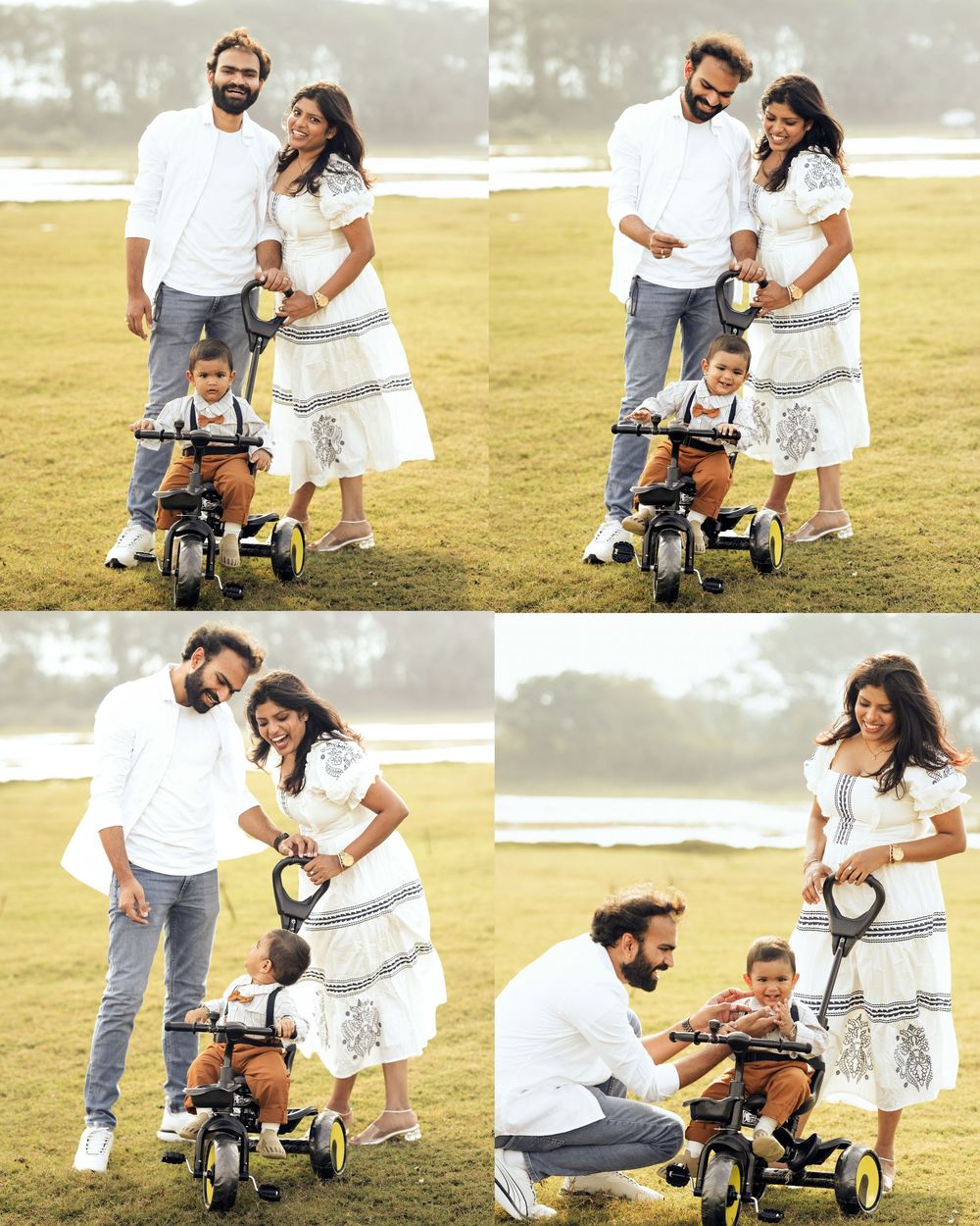 A happy family of three poses outdoors on green grass, with parents in white outfits and a toddler on a tricycle.