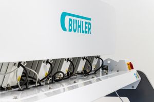 Bühler industrial machine with multiple roller units and mechanical components, featuring the brand logo on white casing.