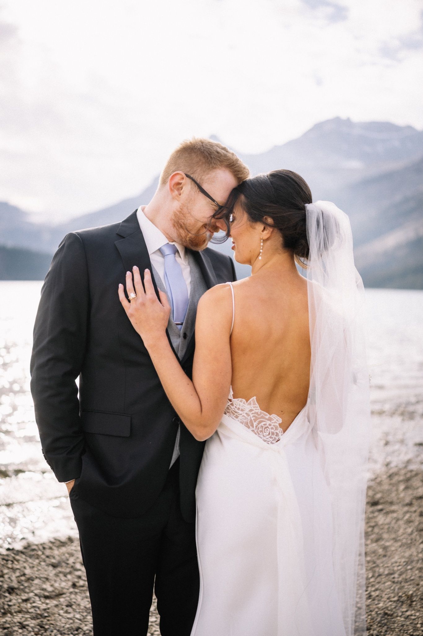 Bride and groom kissing at Bow Lake near Lake Louise