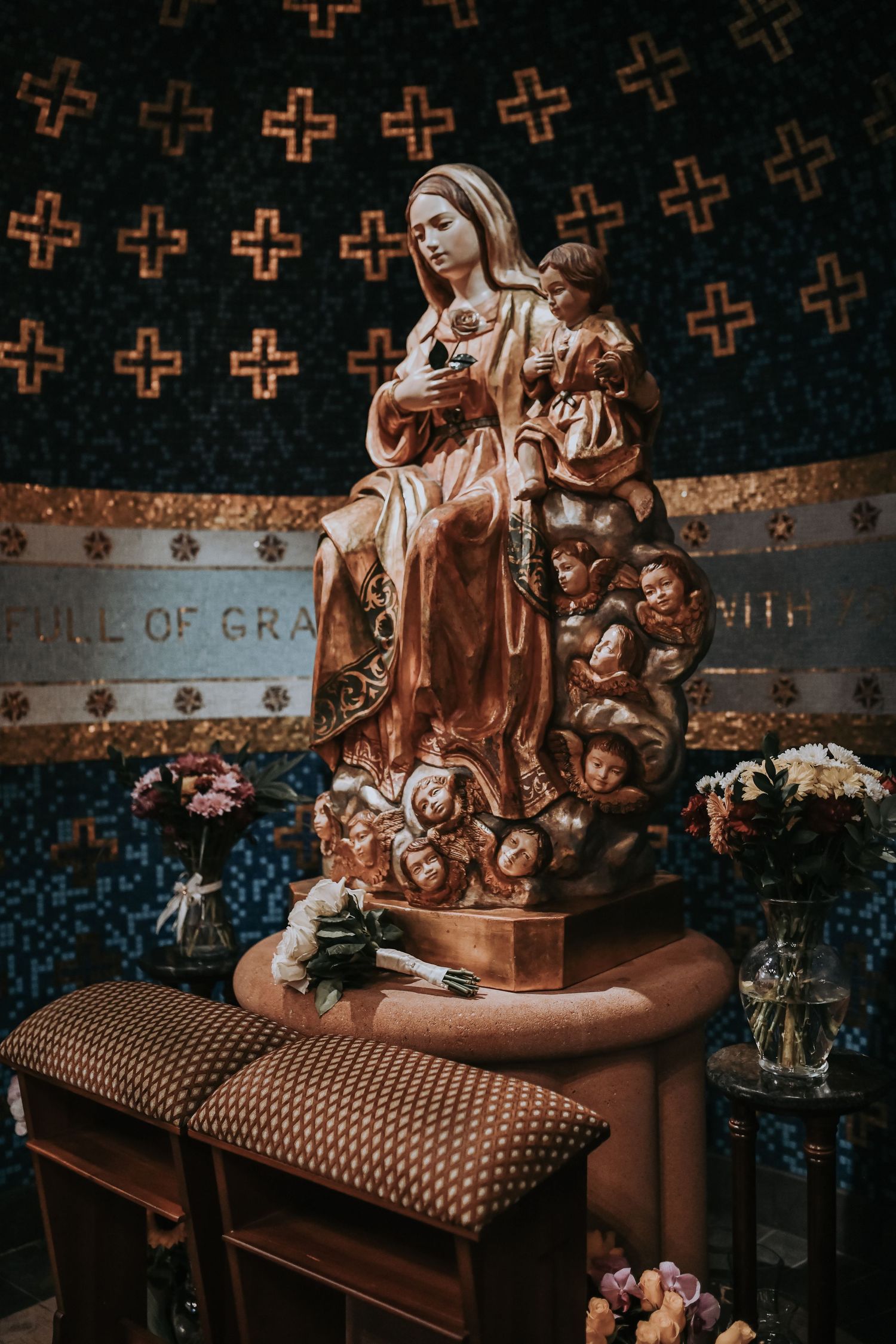 Catholic newlyweds honoring Mary with flowers during wedding Mass