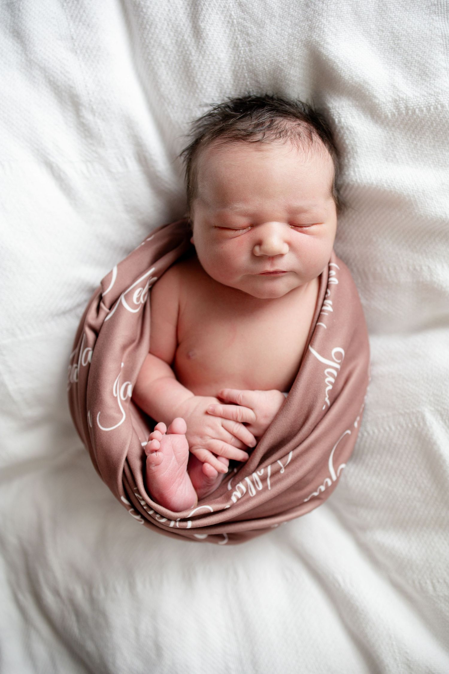 Sleeping newborn baby wrapped in a swaddle during a Fresh 48 session at Parkwest Medical Center.