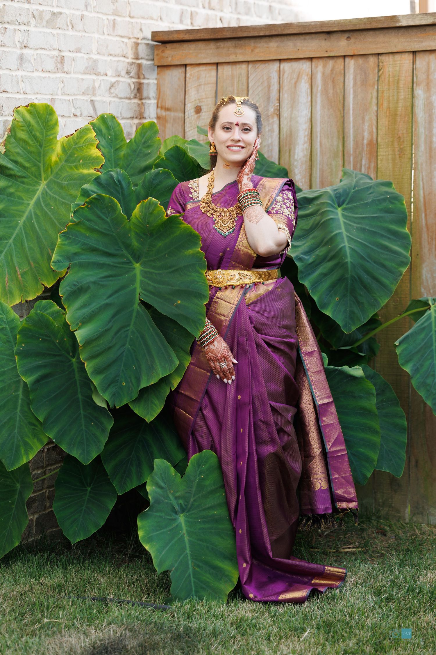 Woman in a purple silk saree with gold border and traditional jewelry by Wedding photographer Memphis TN