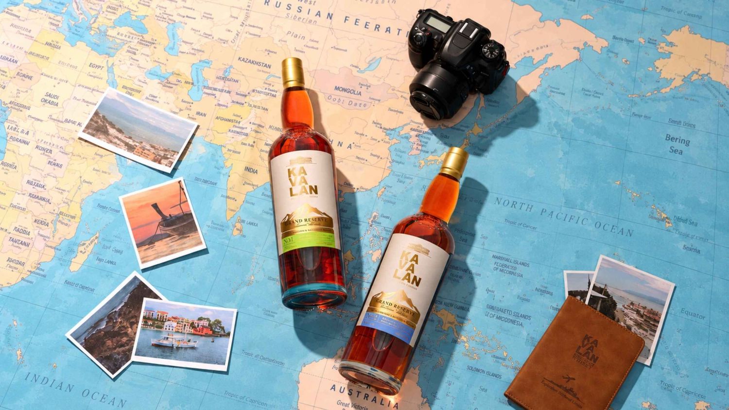 Two Kavalan whisky bottles on a world map with a camera and travel photos.