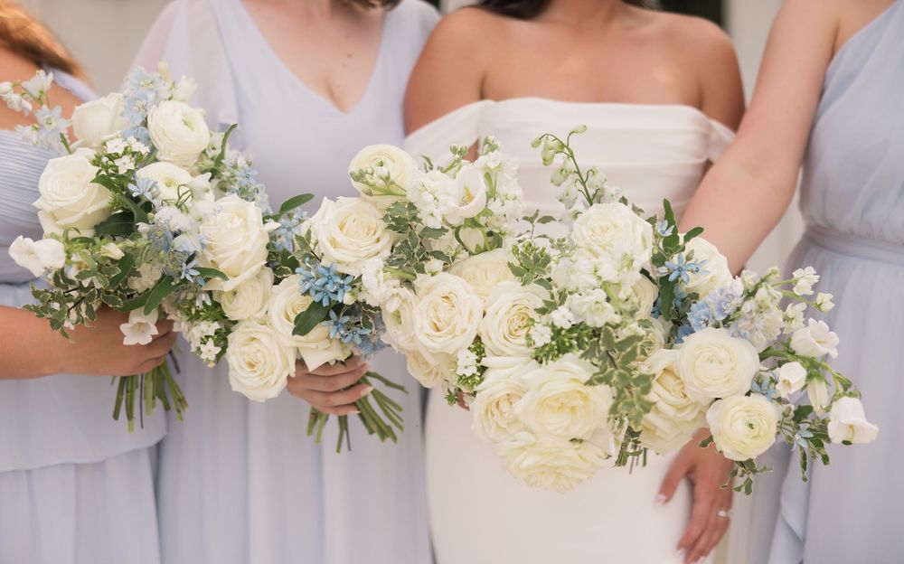 White rose bridal bouquets with blue accents at a Magnolia Hill Farm wedding, Ohio