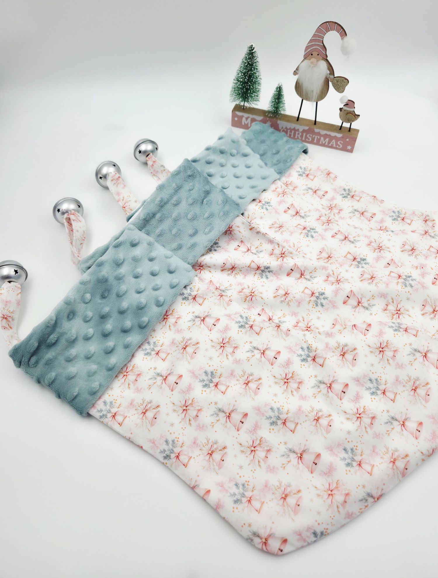 Soft baby blanket with floral print and gray minky dot fabric, displayed near Christmas decorations.