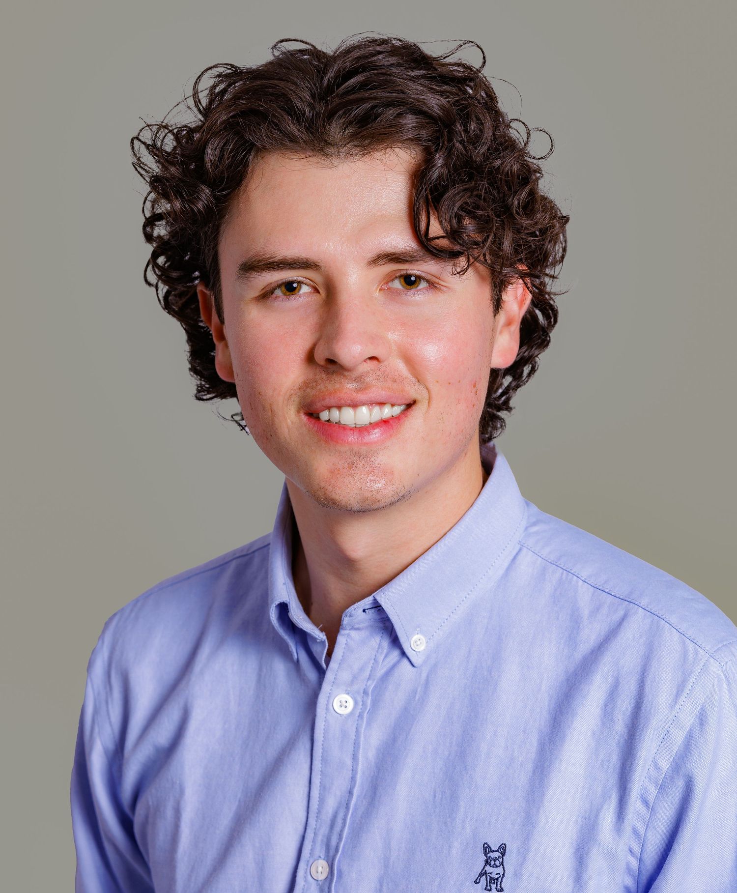 Portrait series showing someone in a light blue button-down shirt against a gray background.