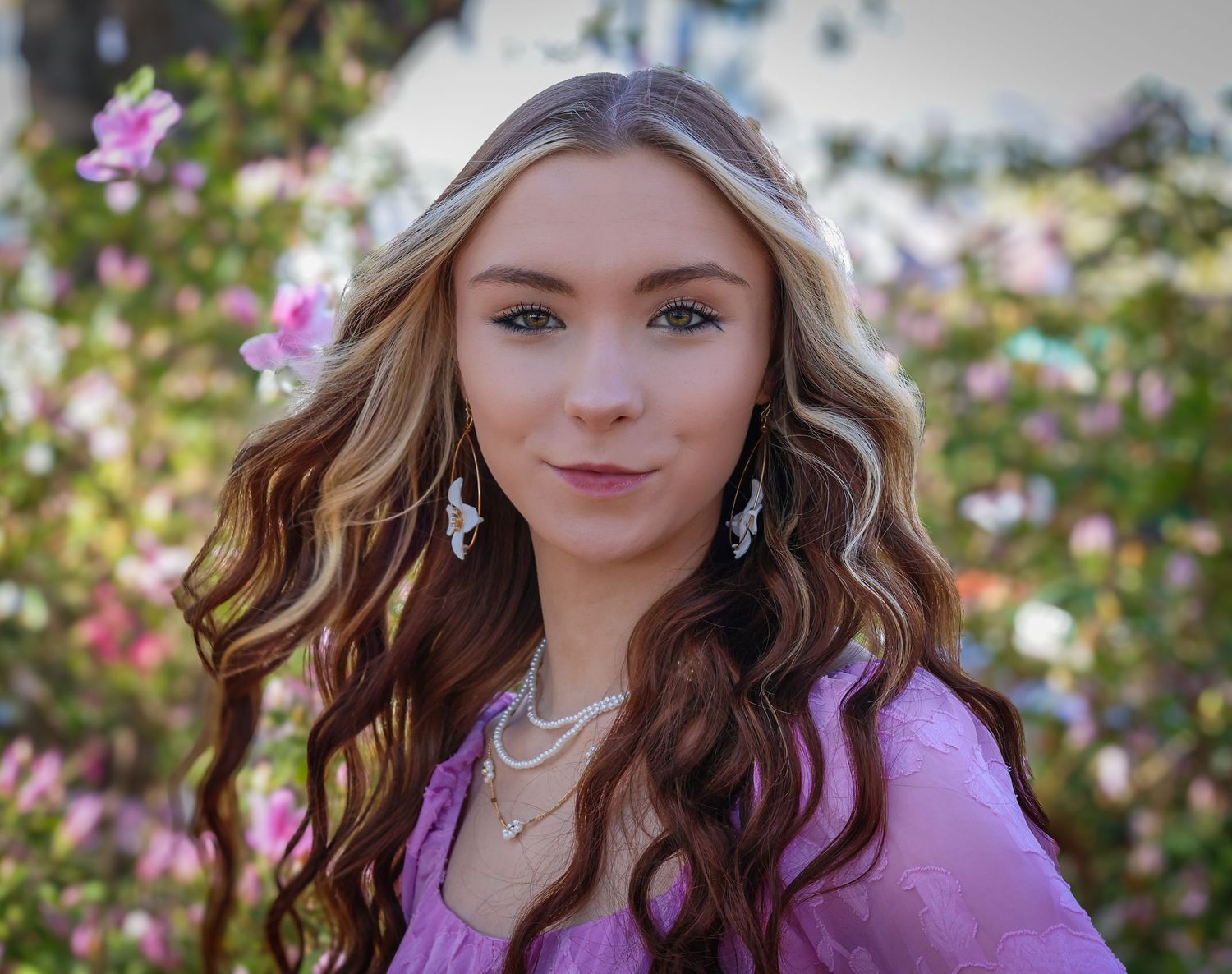 Close-up portraits with purple flowers and natural lighting in an outdoor garden setting.