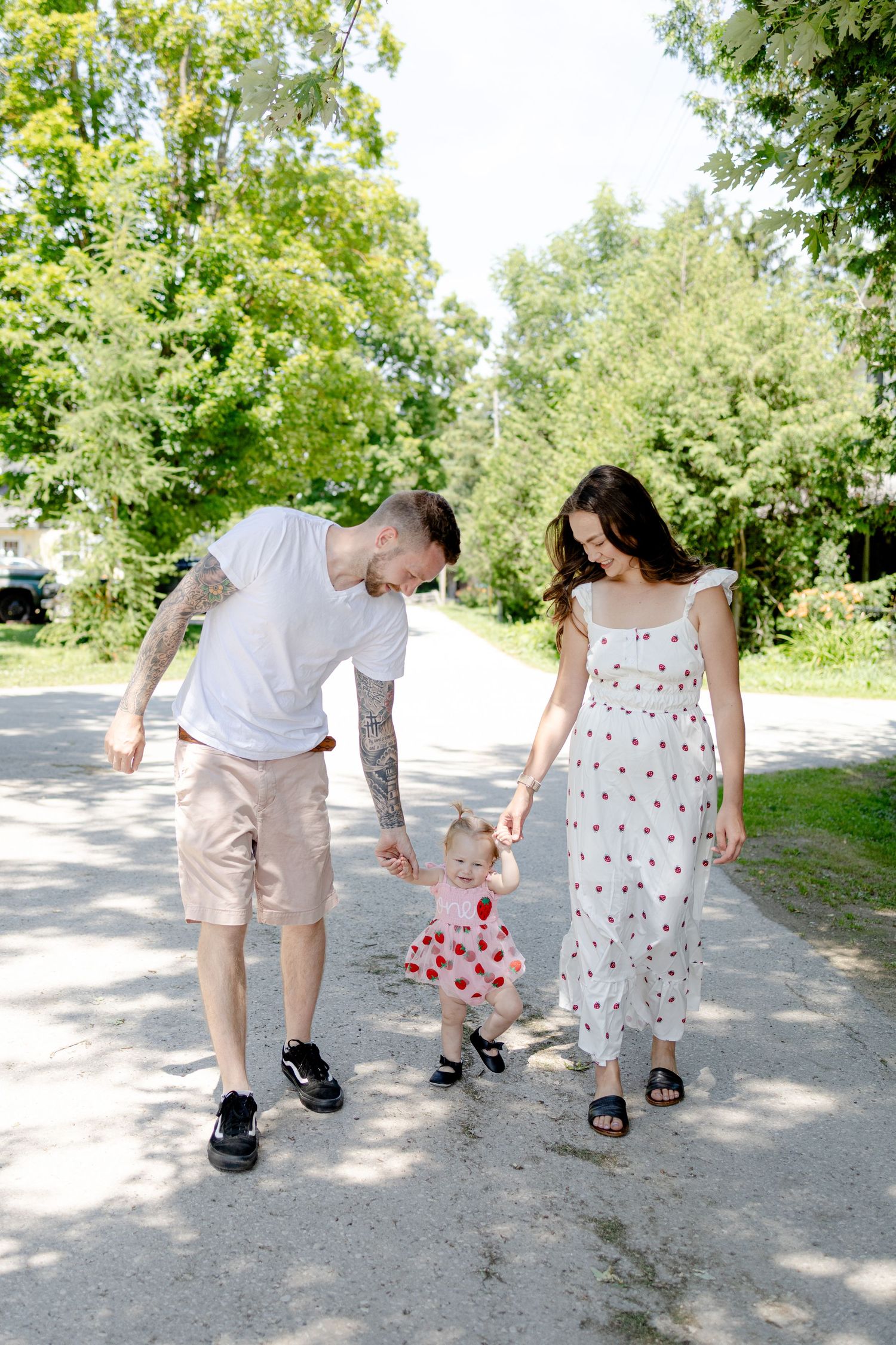 a family holding hands walking down the street during a family lifestyle session