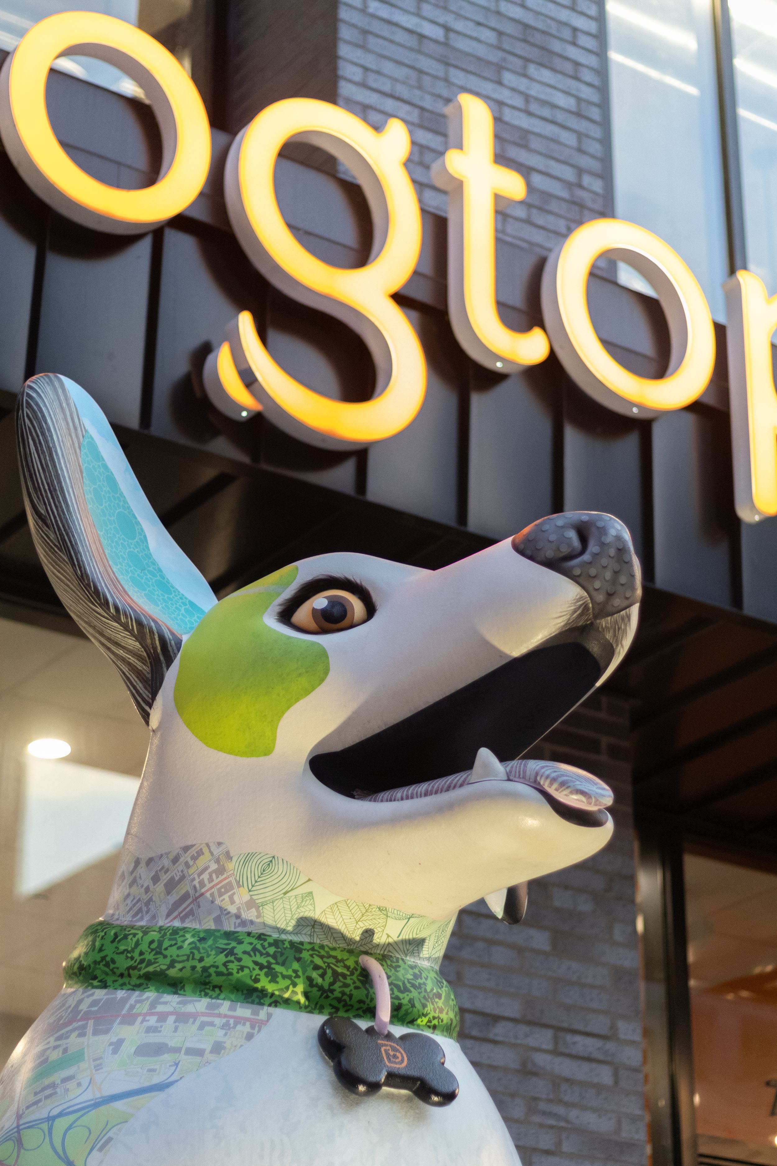 Colorful dog statue displayed outside a Dogtopia pet care franchise location.