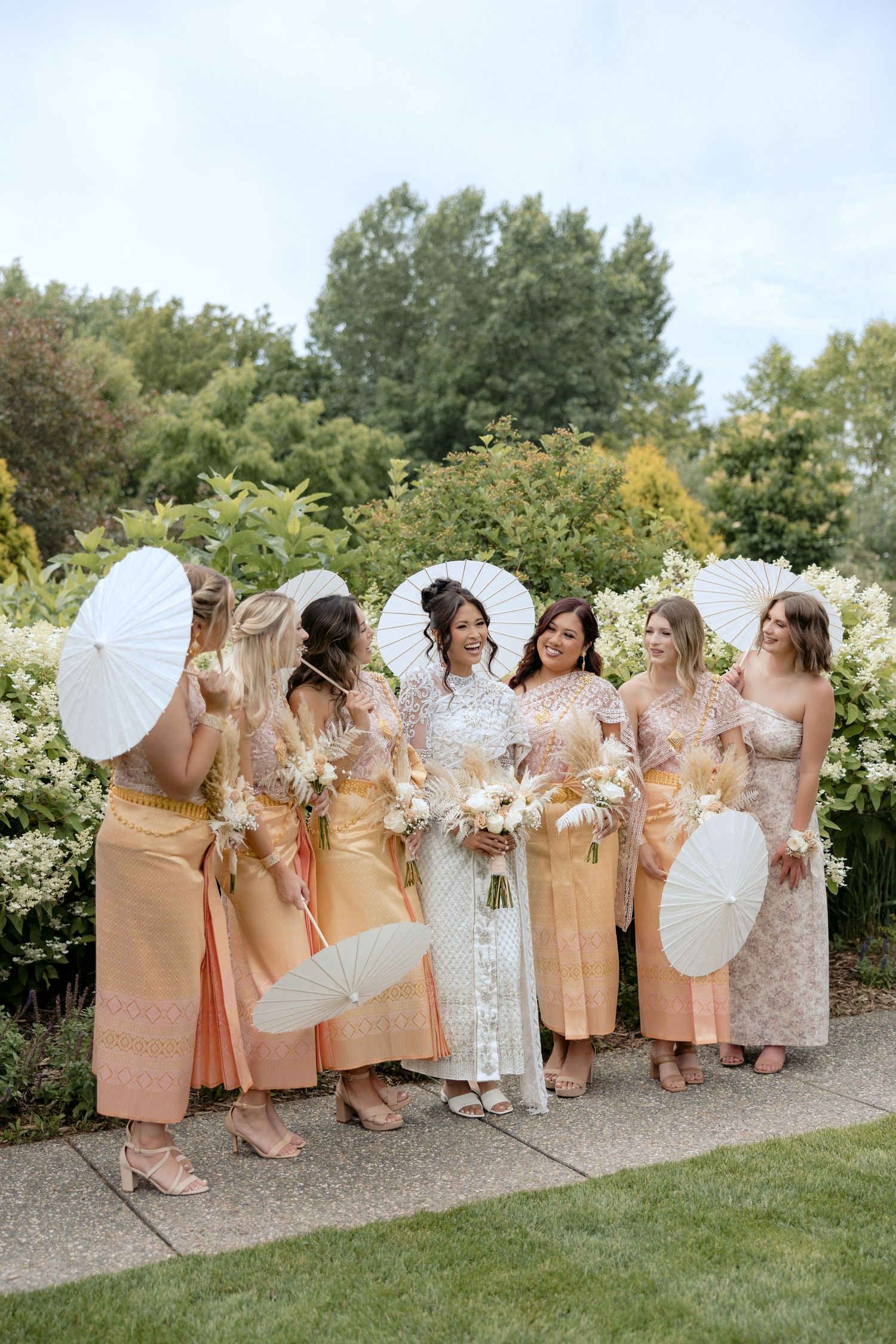 Bride dressed in traditional Cambodian wedding attire smiles with her bridesmaids at this Twin Cities MN wedding.