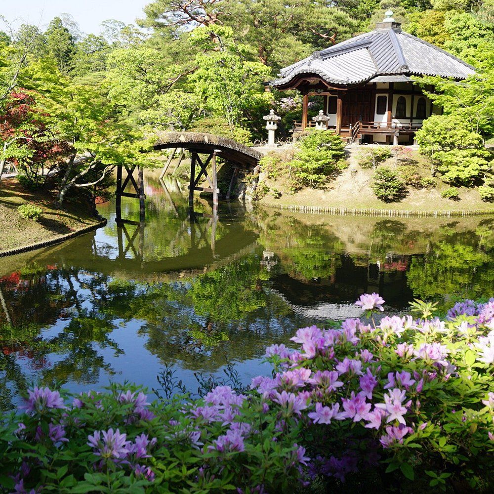 Traditional Japanese Zen rock garden with raked gravel patterns and stones at a Kyoto temple.