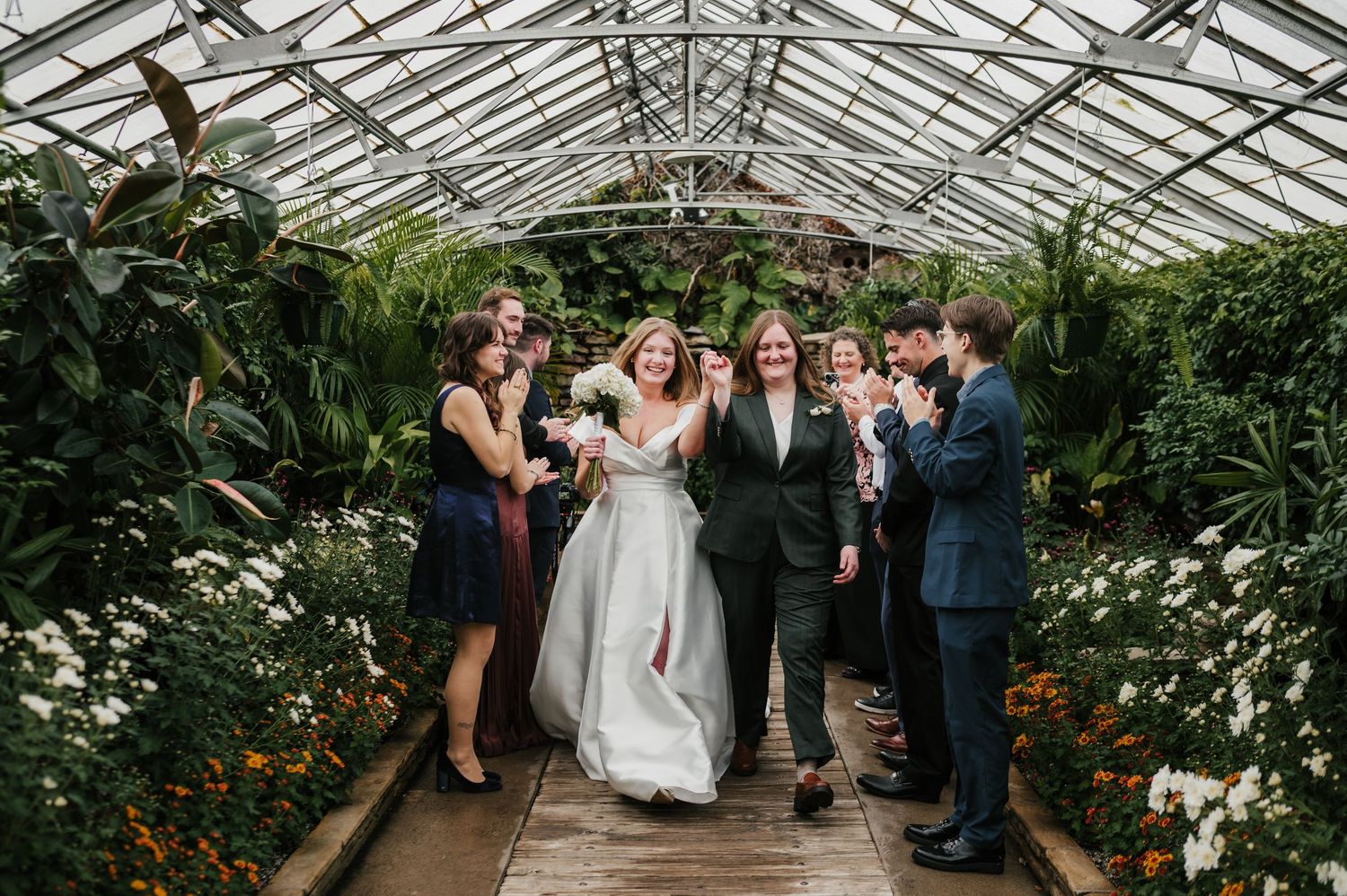 two men jump for joy after Cleveland Metroparks Zoo Wedding at Stillwater Place lgbtq+