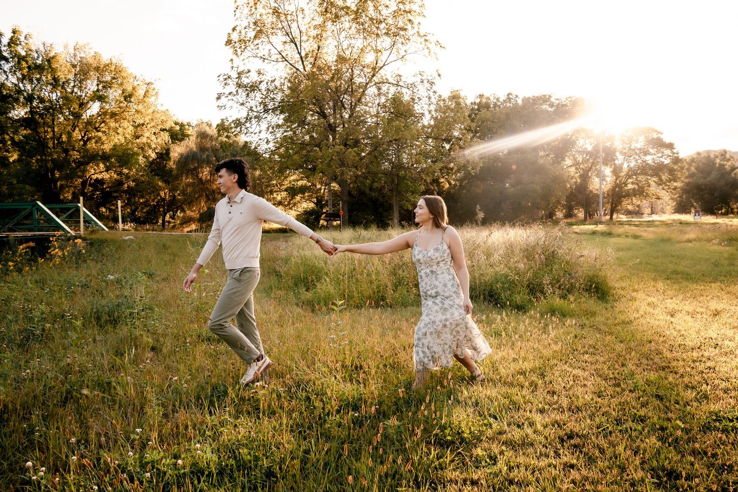 People running and playing in a golden sunset field with dramatic lighting.