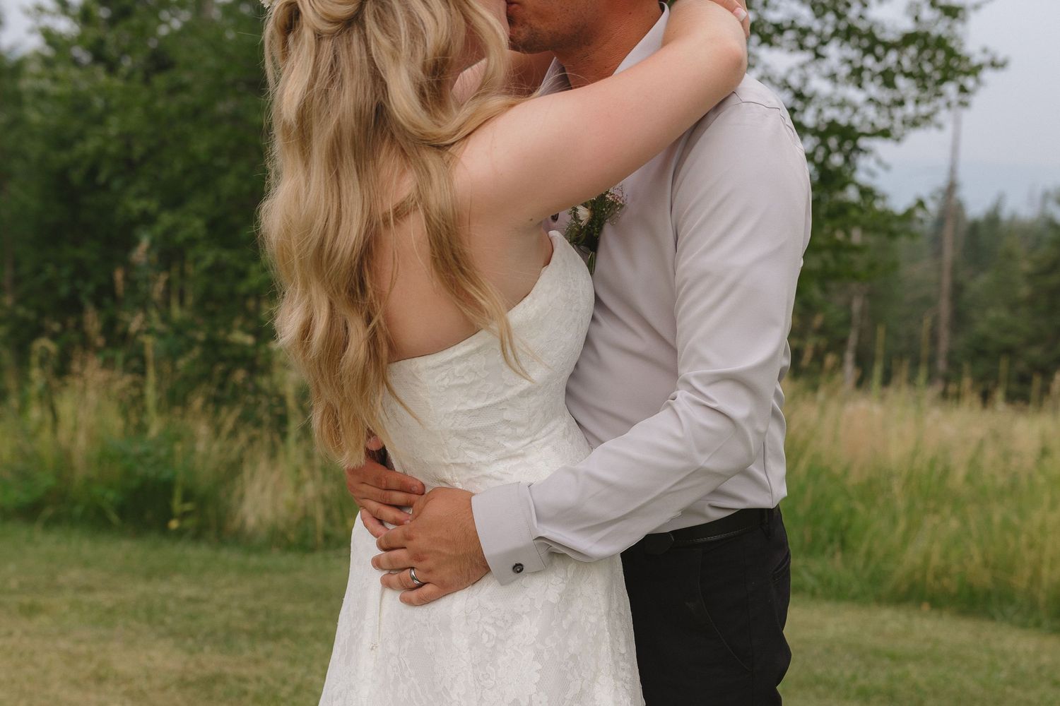 A tender romantic moment between a couple in a sunny summer field.