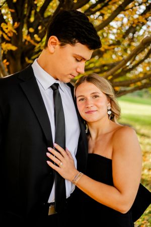 A romantic autumn photoshoot with golden leaves in the background.