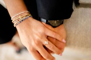 Close-up details of jewelry and hands during an engagement photoshoot.
