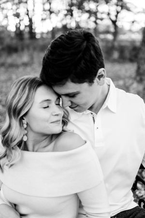 Romantic black and white photo series of a couple sharing intimate moments in a natural outdoor setting.