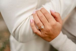 Close-up detail shots of hands and tender moments during engagement photoshoot.