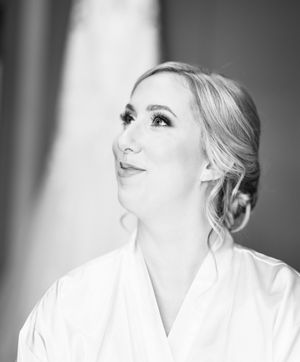 A black and white portrait shows someone in a white shirt looking upward with a dramatic side profile pose.