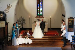 A wedding ceremony sequence showing a couple at the altar progressing through different moments in a church service.