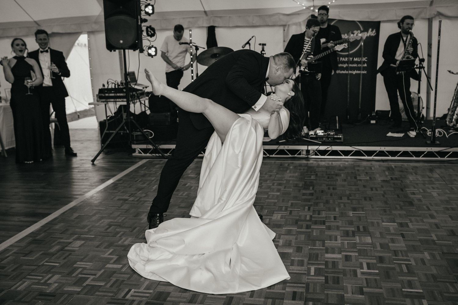 Wedding couple dancing together on a parquet floor during their reception.