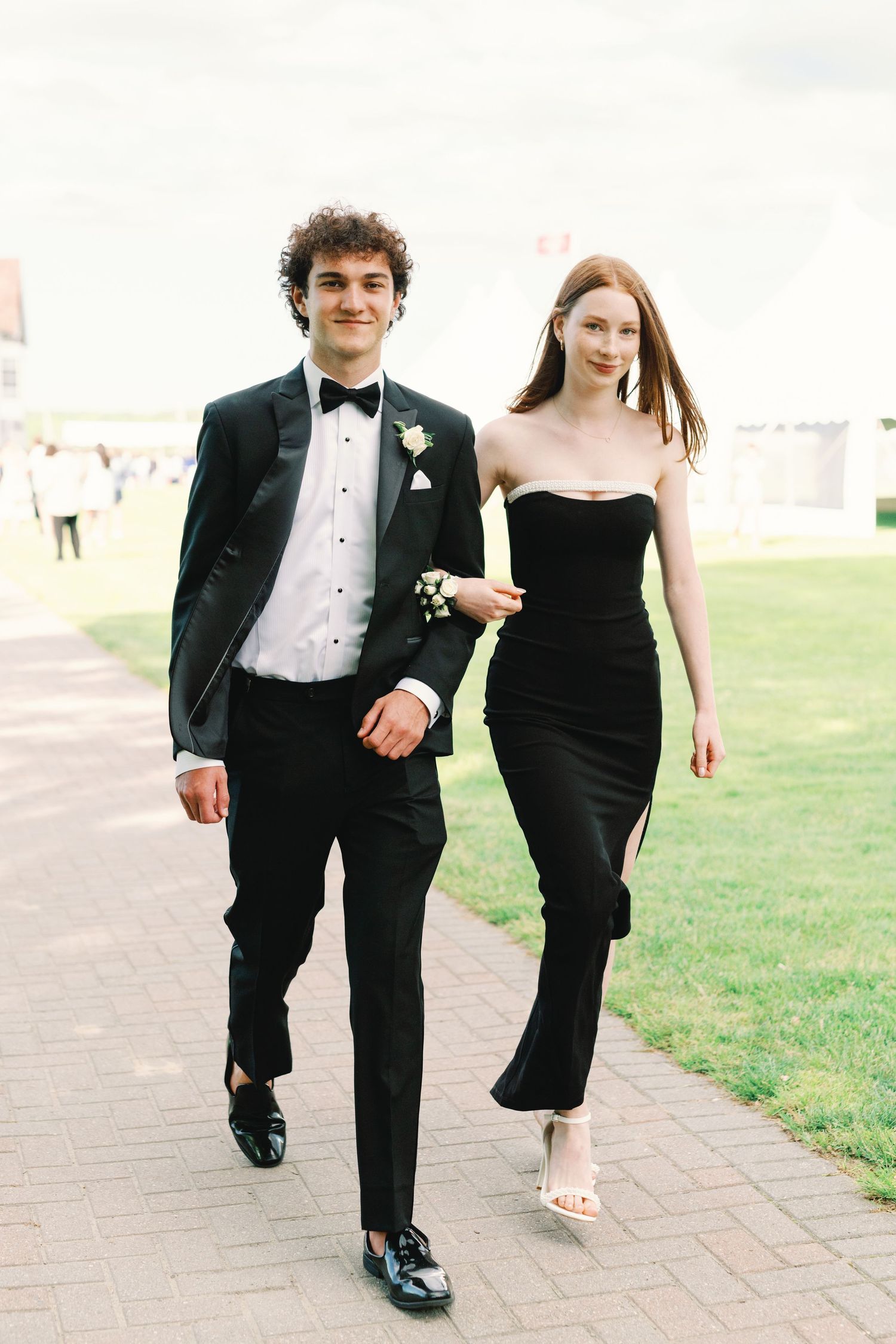 A series of formal event photos showing couples walking together on a path wearing black tie attire.
