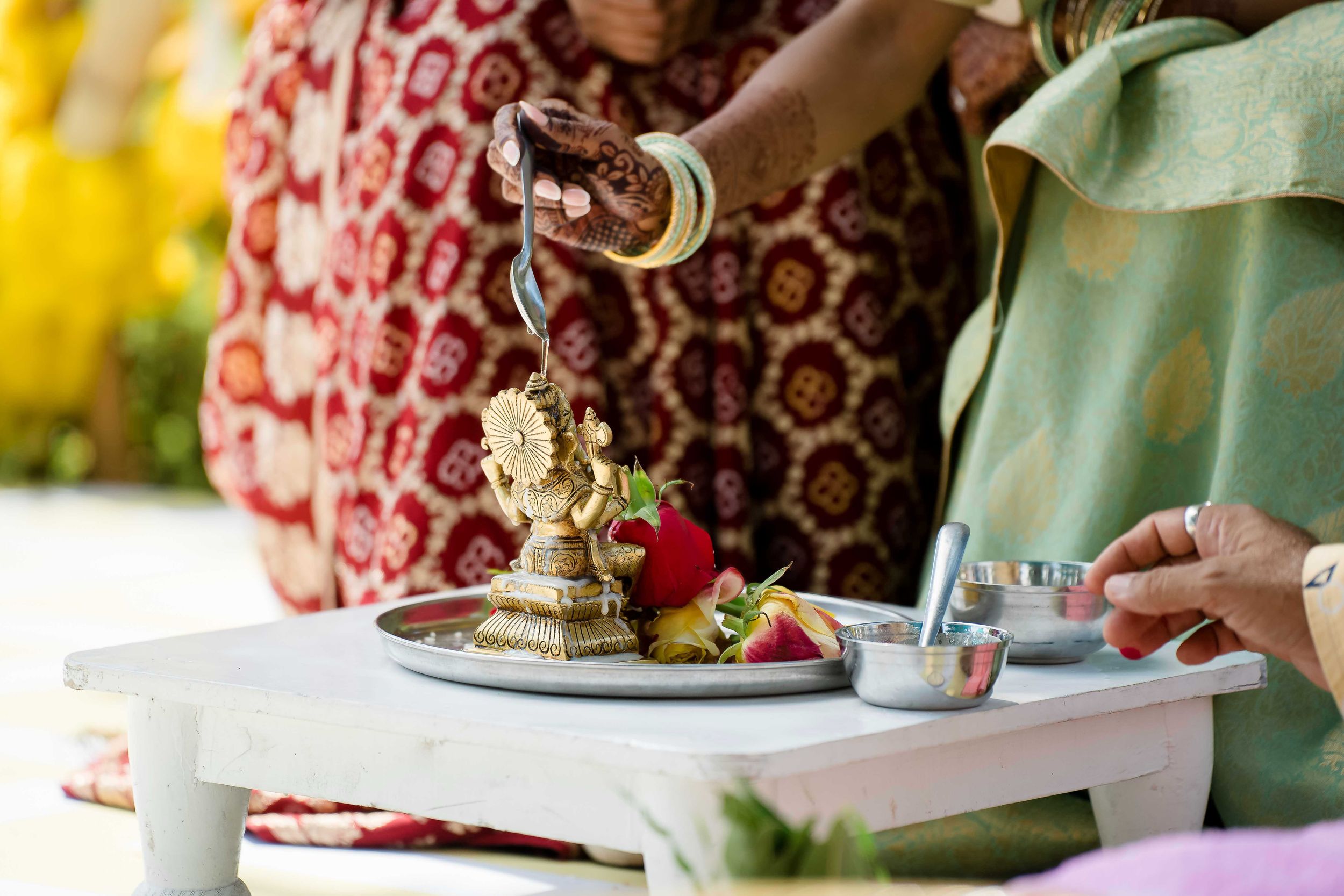 A romantic outdoor tea party setup with pastel colors, delicate teacups, and floral arrangements on a decorated table.