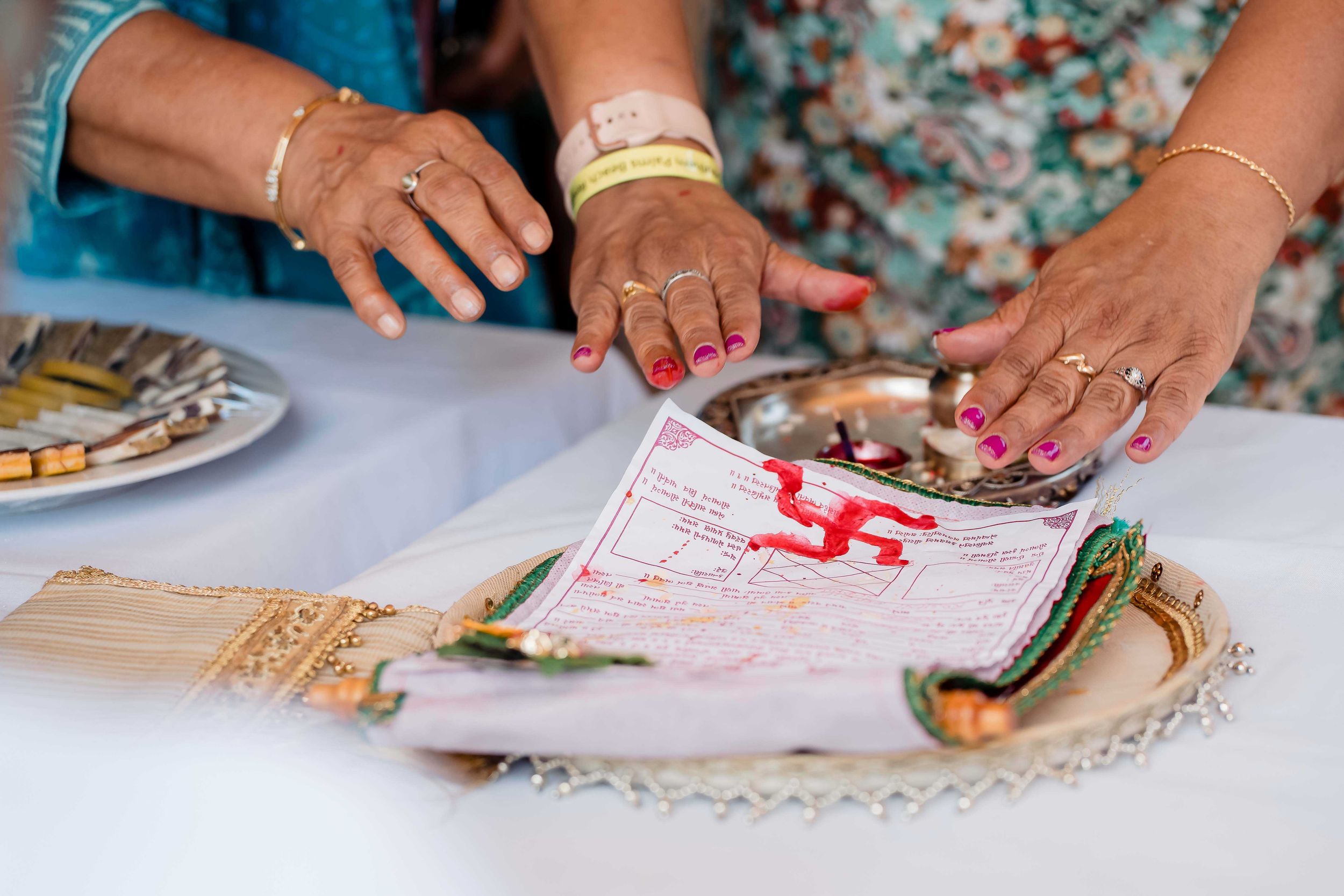 Close-up view of hands rolling and preparing homemade flour tortillas on a floured surface.