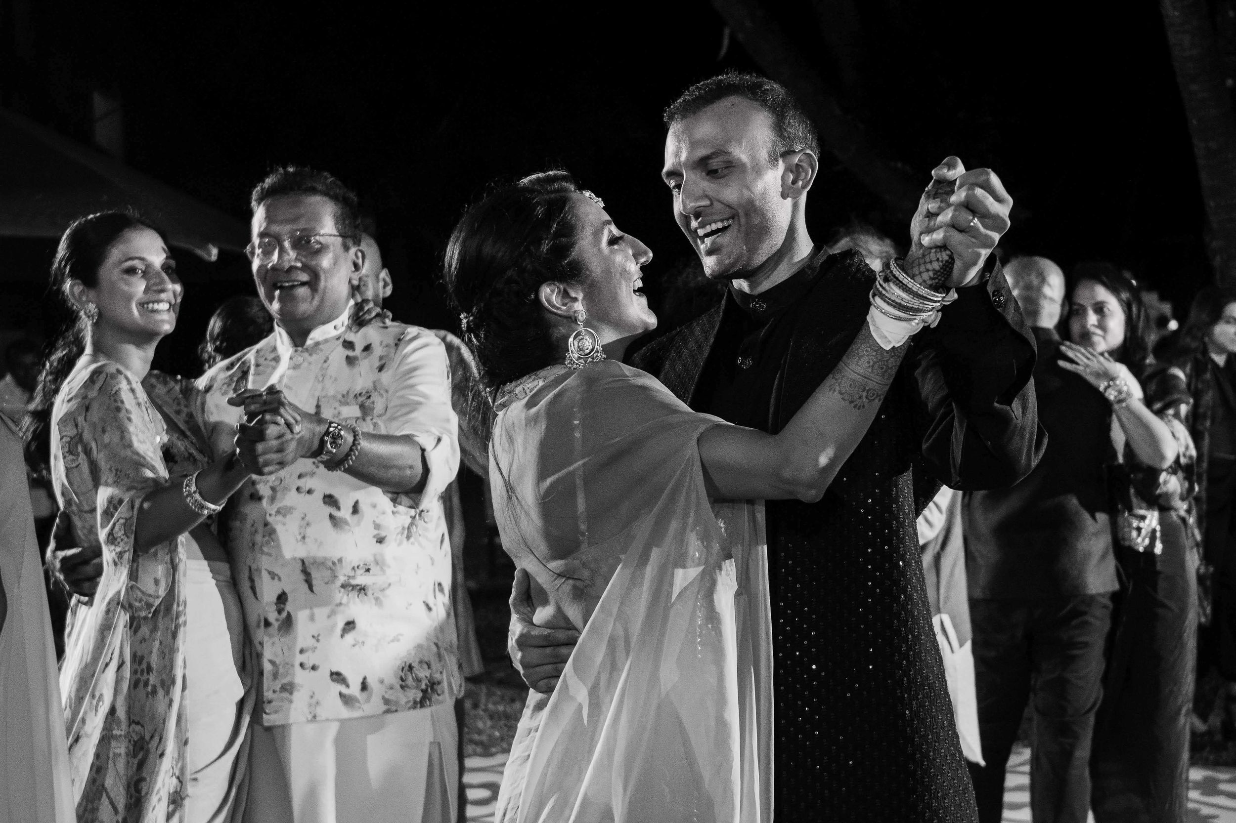 Black and white photo of couples dancing together at an elegant evening celebration.