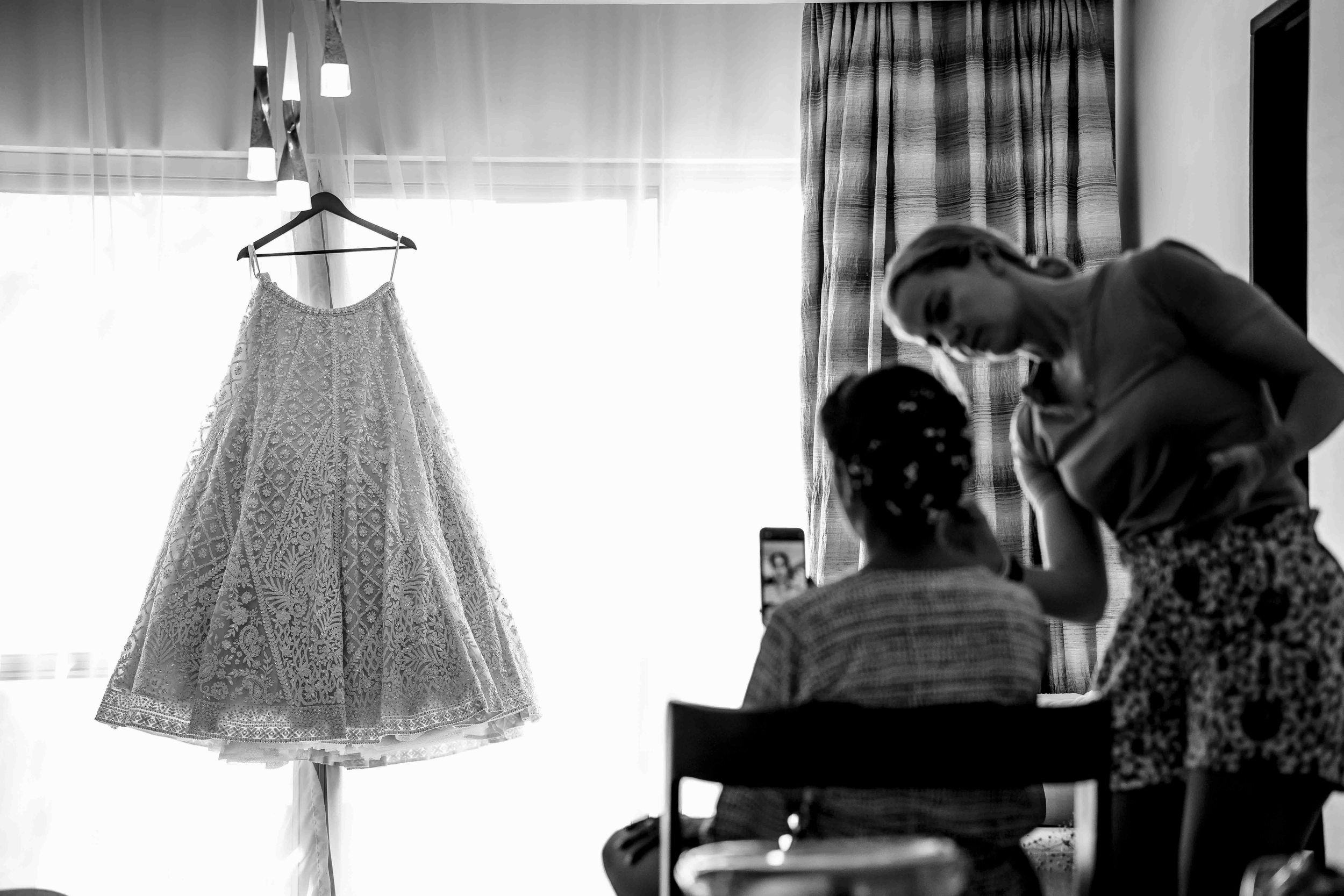 Black and white collage showing vintage dresses and clothing hanging on garment racks in a fashion boutique setting.