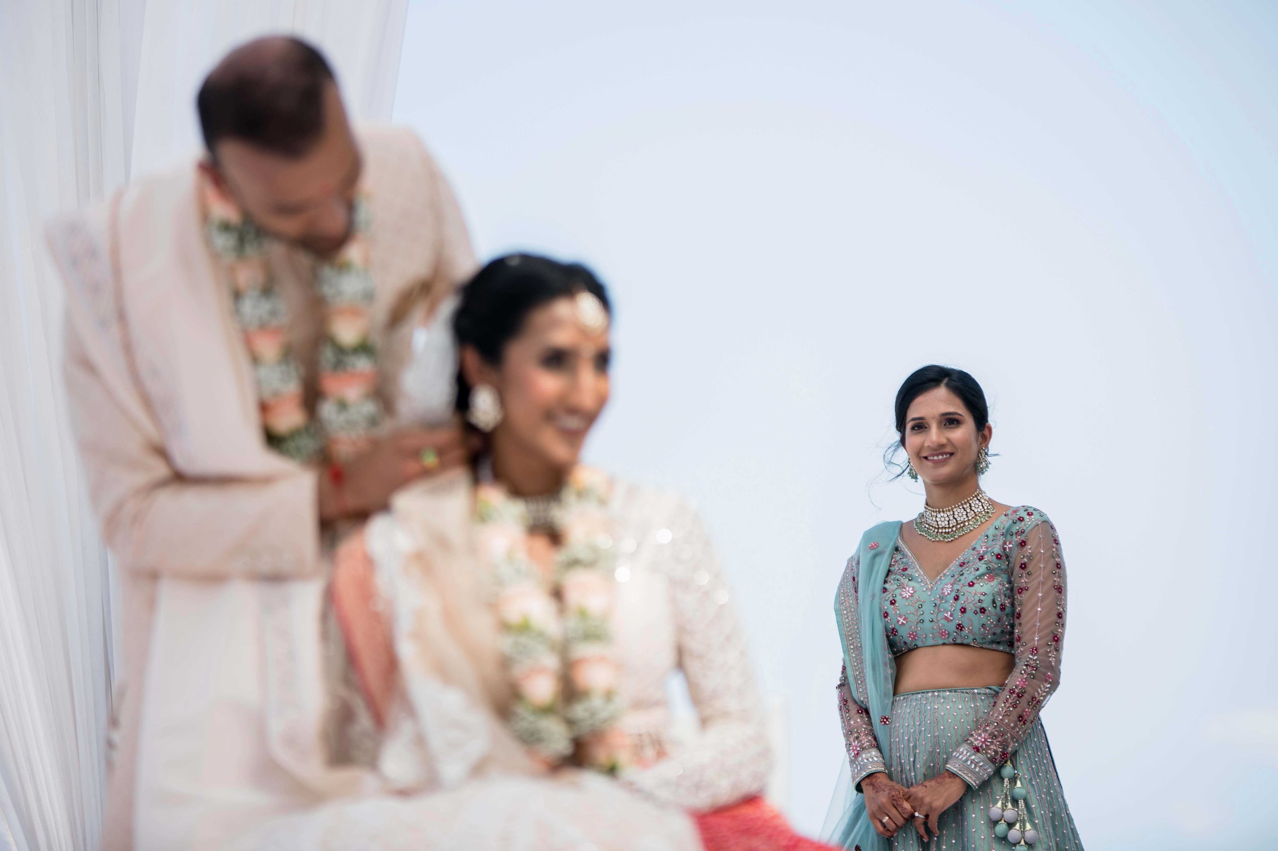 A traditional Indian wedding ceremony with people in elegant attire and decorative outfits.