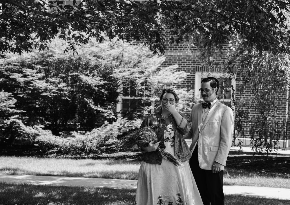 A black and white portrait of a fiancee surprised at engagement photoshoot in Gettysburg College.