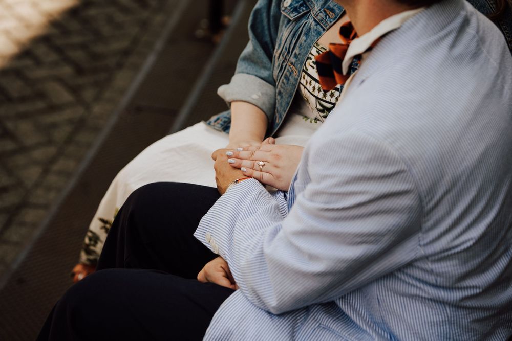 Two people sitting close together holding hands by staircase in Gettysburg College