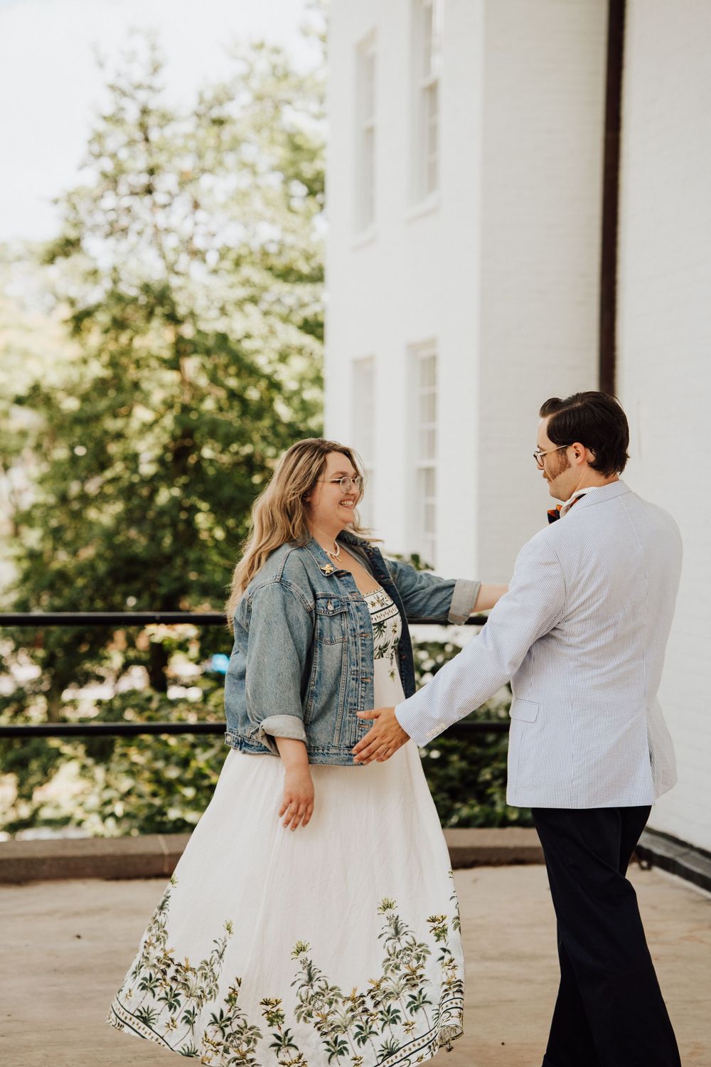 A couple shares a fun moment dancing in Gettysburg College Campus