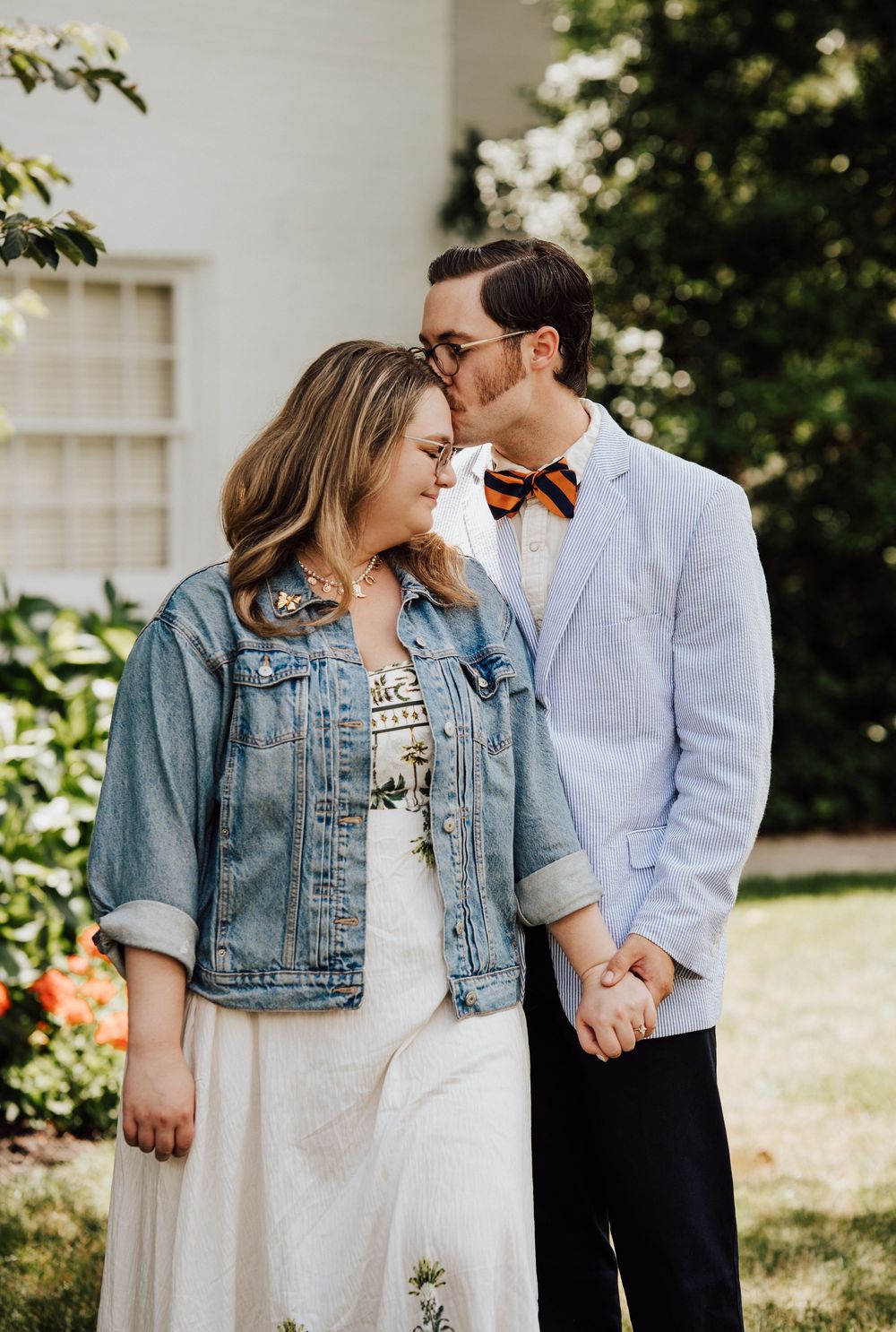 A romantic couple shares a tender moment outdoors, at Gettysburg College for engagement photoshoot in Adams County
