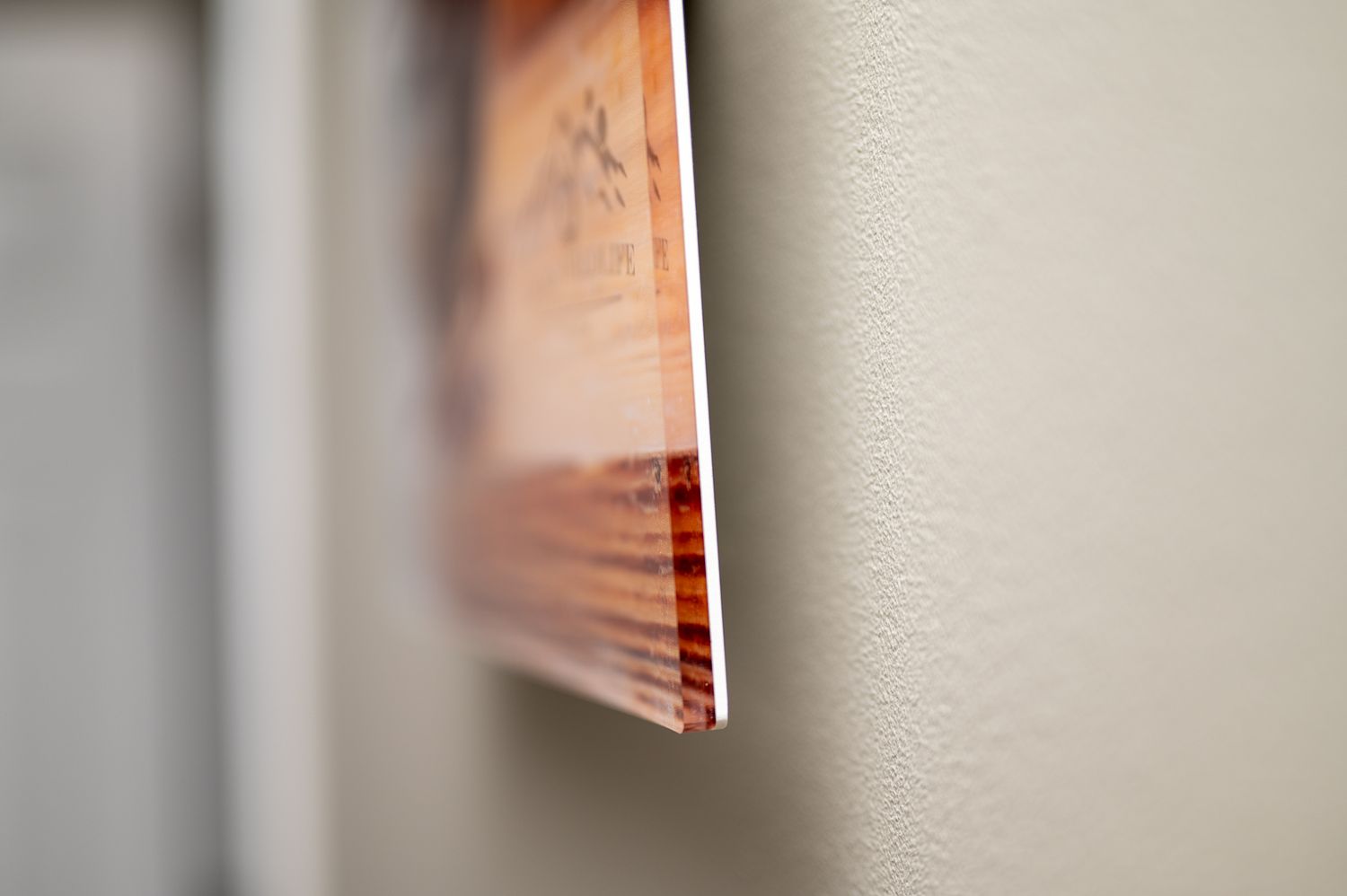 Close-up view of the corner of a book or document against a blurred white background.