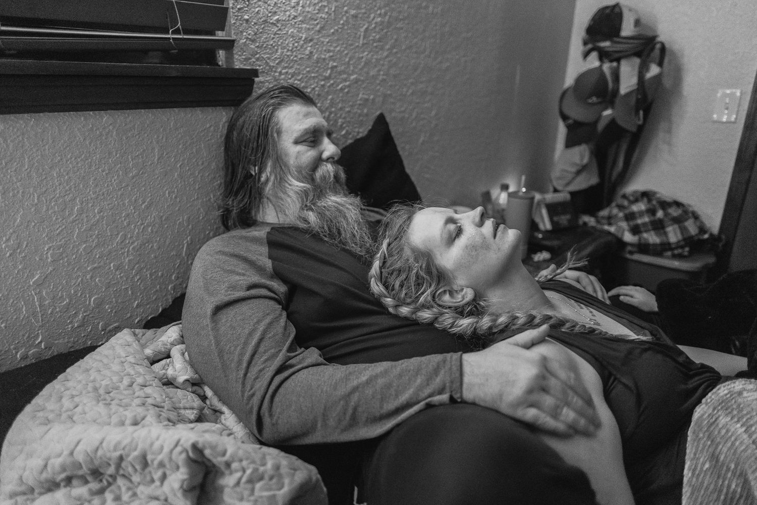 Black and white photo series showing exhausted people sleeping in various unconventional positions and locations.