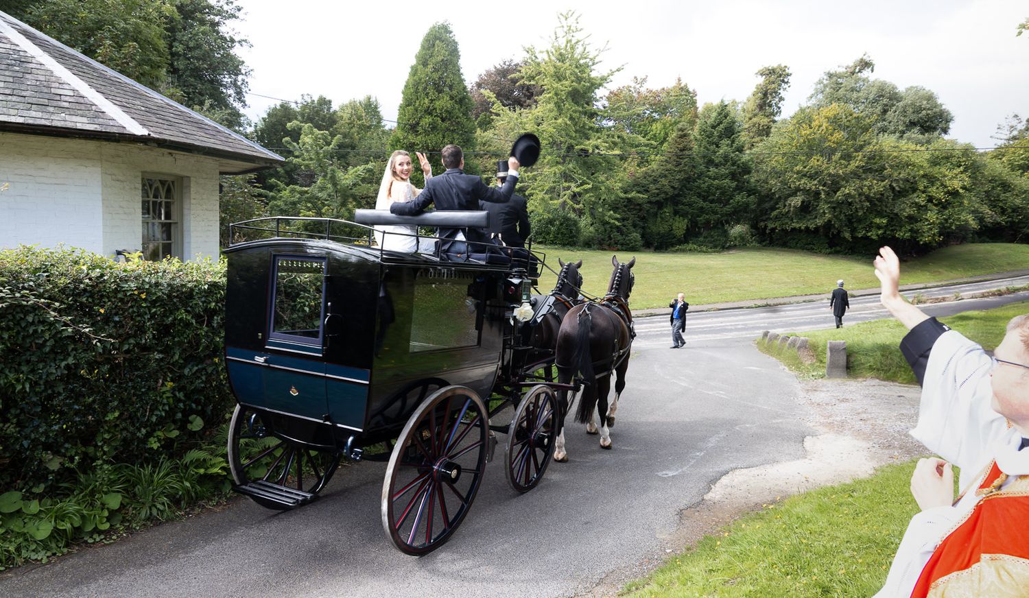 Horse and carriage pulls wedding couple at Horsted church, Sussex