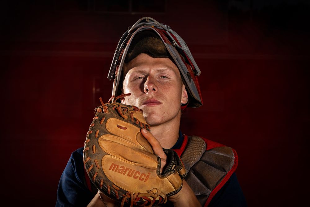 A vintage-style baseball scene with brown leather baseball glove against a dark red dramatic background.