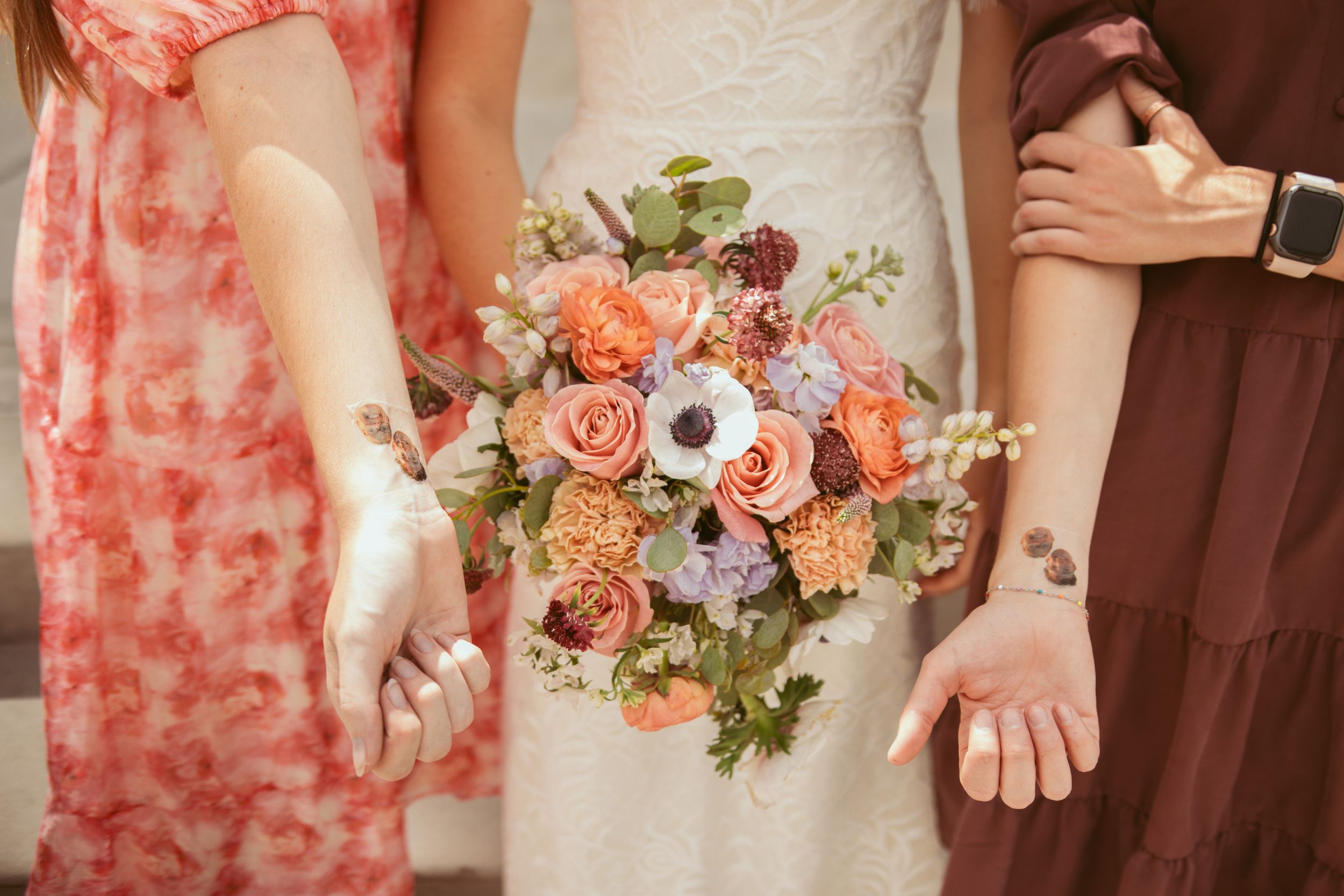 Coral colored flowers and blush wedding bouquets arranged in a collage of floral details from a bridal party.