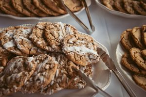 Close-up view of homemade chocolate chip cookies cooling on a wire rack shows golden brown edges and melted chocolate chips.