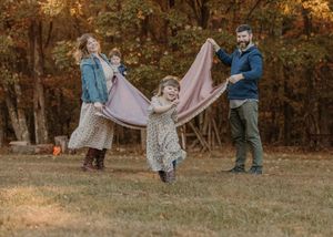 A series of autumn outdoor photos showing people dancing and twirling in flowing dresses among fall foliage.