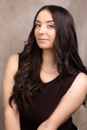 A series of photos showing a dark-haired person in a black sleeveless top posing against a neutral backdrop.