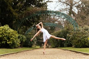 A series of sequential photos showing a person performing a graceful dance movement in an outdoor garden setting.