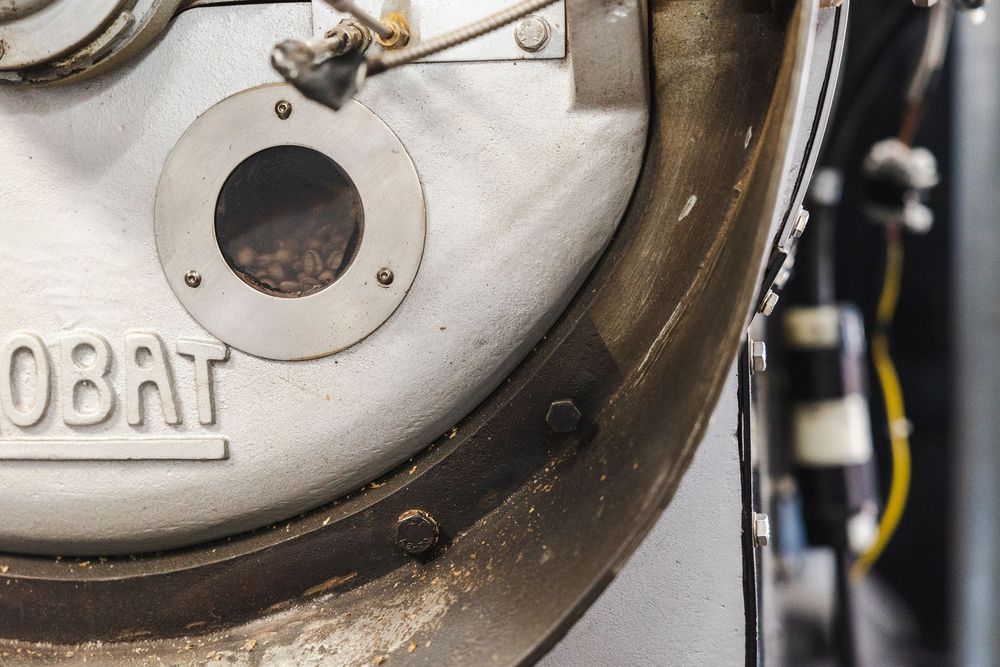 Close-up detail of a vintage Hobat equipment showing metal surface texture and circular porthole design.