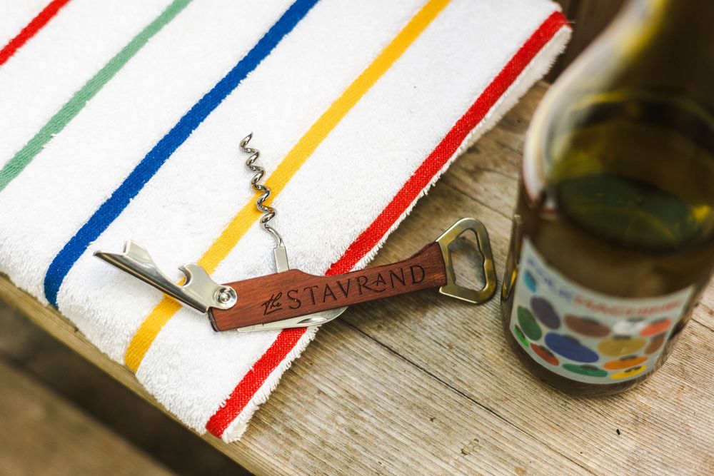 Colorful striped kitchen towels with blue, red, yellow and green stripes displayed on a wooden surface.